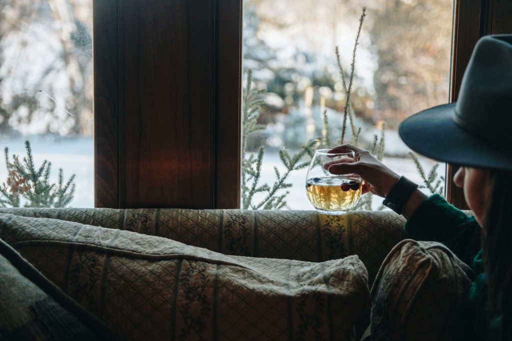 A woman sitting on a couch in front of a window