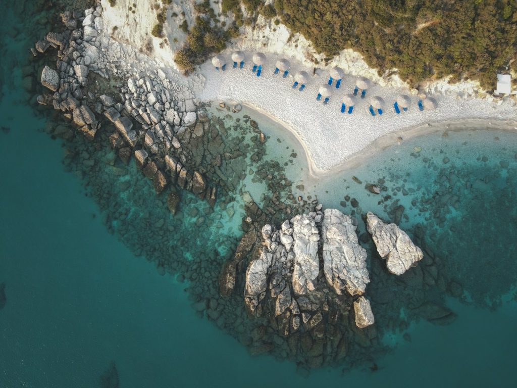 An aerial view of a sandy beach and water